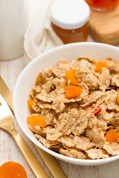 Cereals with dry fruits in bowl and jam