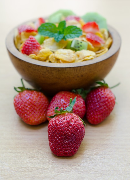 Cereals with fruit in wooden bowl 