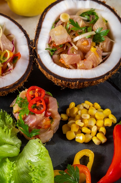 Ceviche dish - appetiser of fresh fish marinated in citrus with tropical fruits served in a Coconut Bowls.