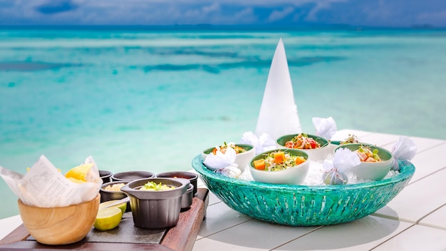 Ceviche gourmet sea food on white table. Delicious ceviche of shrimp with vegetables, spices