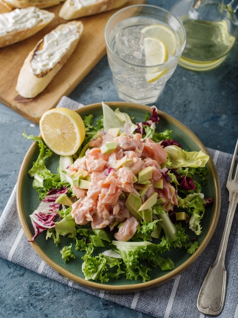 Ceviche is a traditional dish from Peru. Salmon marinated in lemon with fresh lettuce, avocado and onions