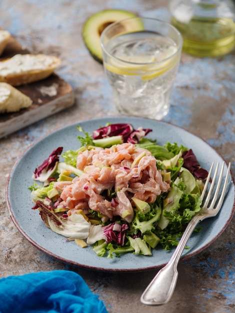 Ceviche is a traditional dish from Peru. Salmon marinated in lemon with fresh lettuce, avocado and onions