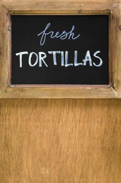 Photo chack board with fresh tortillas sign.