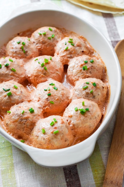 Chacken meatballs baked in creamy tomato sauce