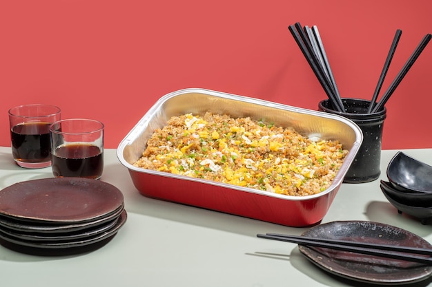 Chahan food tray with drinks and chopsticks isolated on grey background side view