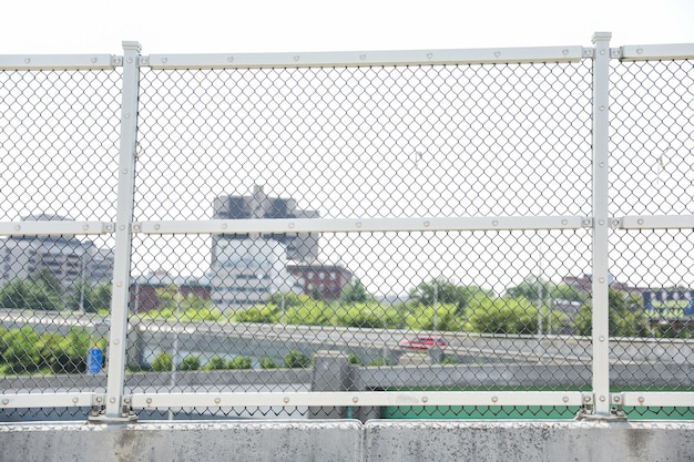 A chain link fence with a sign that says " green " on it.