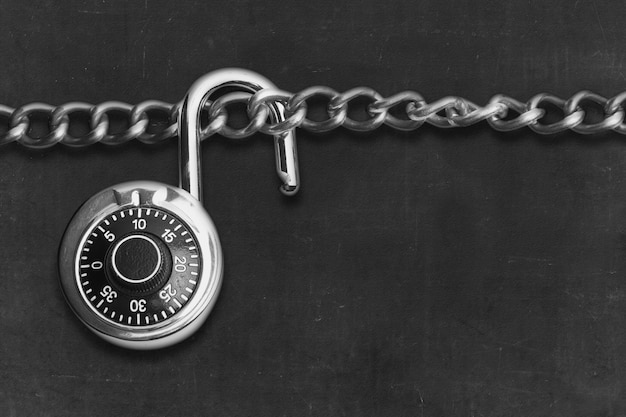 Chain of metal steel with padlock and black background