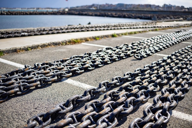 Chains for ships lies on the pier against the background of a cloudy sky and the Black Sea