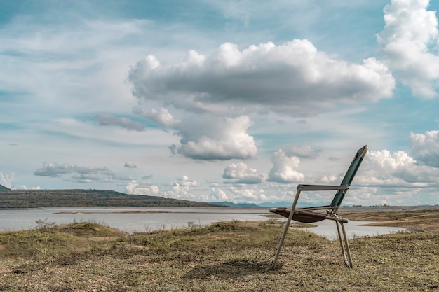 Chair beside the reservoir in Mae Karm Lake reservoir With the morning atmosphere with beautiful sky and clouds.