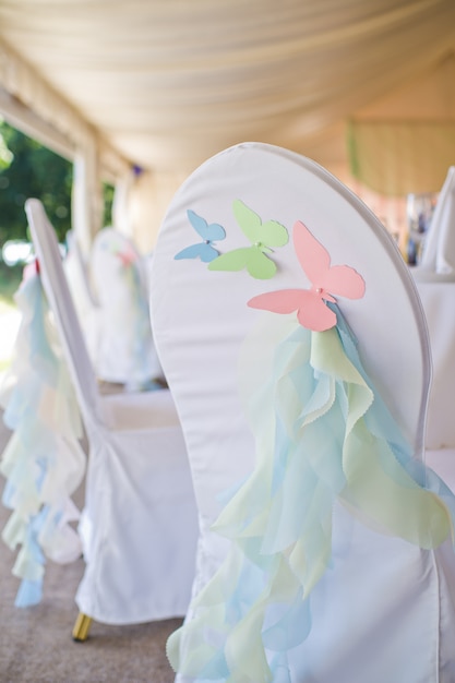 Chair decorated with butterflies made of paper.