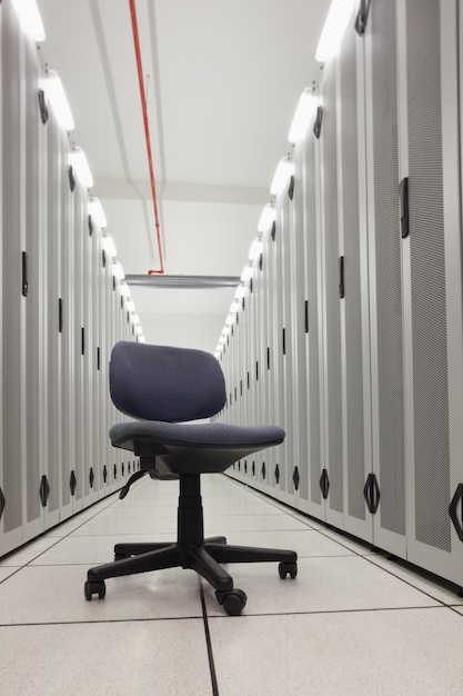 Chair in empty row of servers