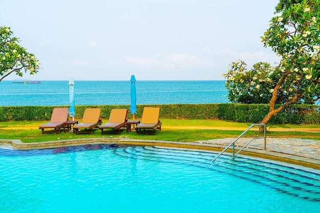 Chair pool around swimming pool with sea background