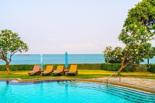 Chair pool around swimming pool with sea background