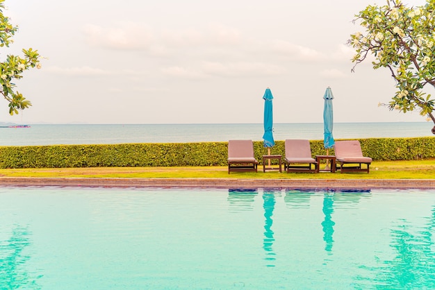 chair pool or bed pool with umbrella around swimming pool