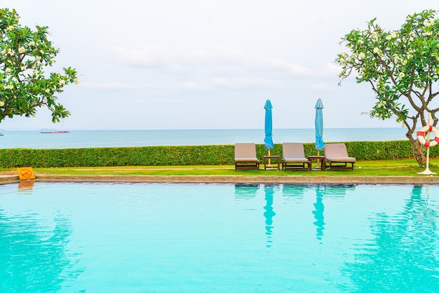 Photo chair pool or bed pool with umbrella around swimming pool