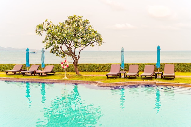 chair pool or bed pool with umbrella around swimming pool