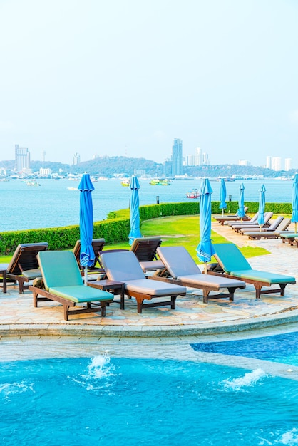 Chair pool and umbrella around swimming pool with sea views