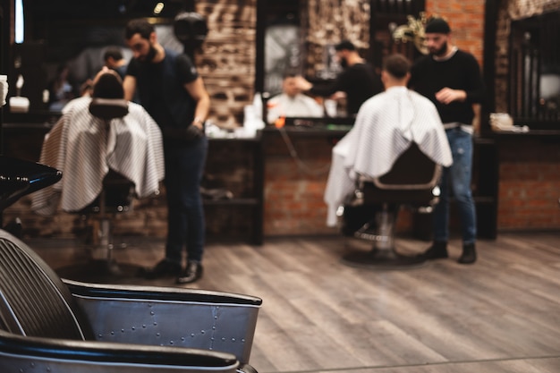 Chair for washing your hair in barbershop. Barbershop interior. Brutal place. Leather armchair with metal upholstery