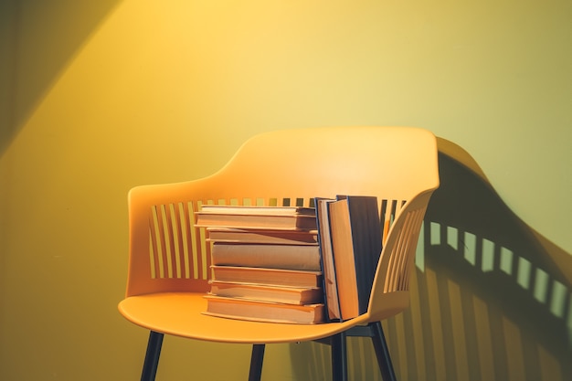 Chair with books near color wall