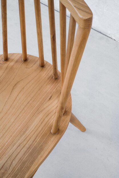 A chair with a wooden seat and legs.