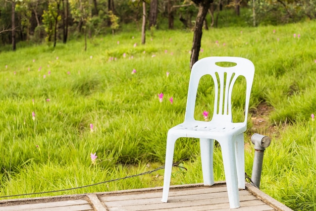 Photo chair on wooden platform against field