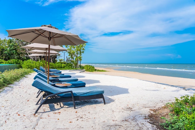 Chairs on beach against sky