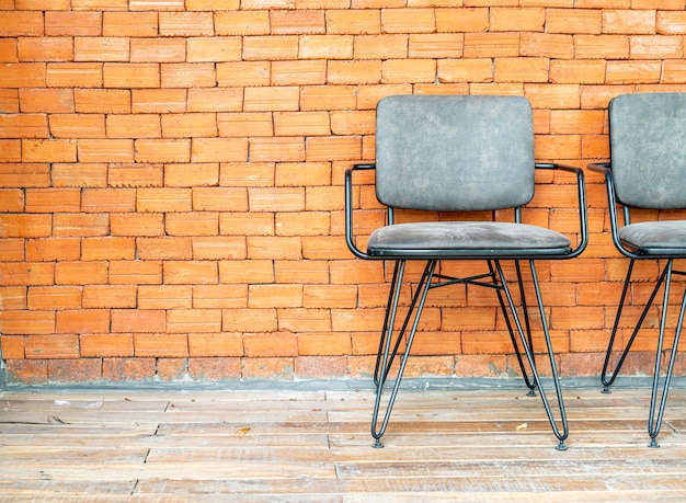 Chairs on brick wall