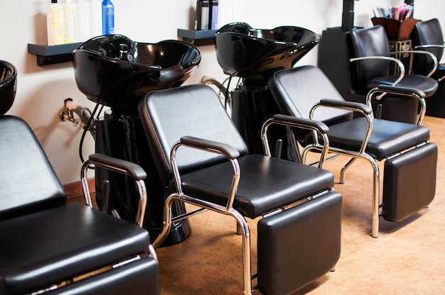 Photo chairs by sink bowl at hair salon