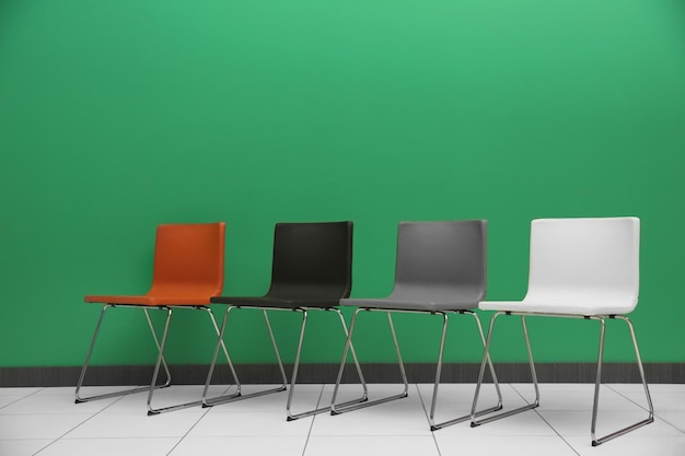 Photo chairs on color wall background