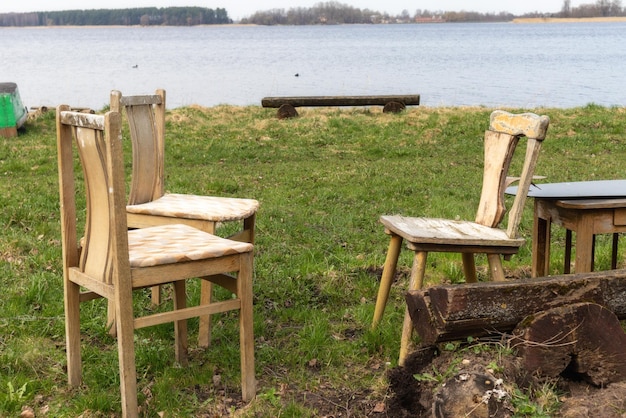 Chairs in a field next to a lake