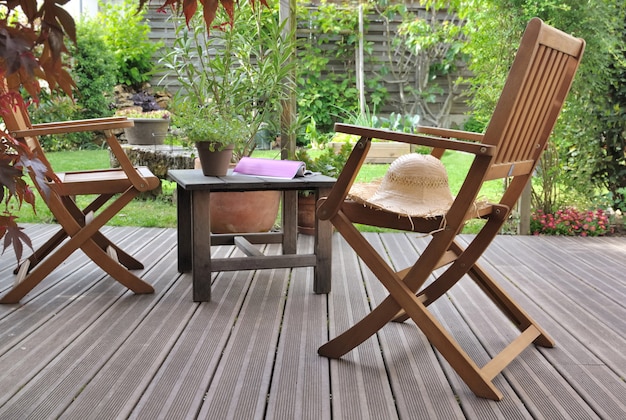 Chairs to relaxe on wooden terrace  in a garden