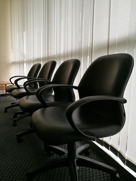 Photo chairs in row on floor at office