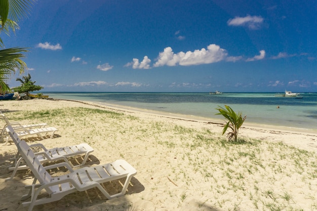 Chairs on sand beach in tropical paradise