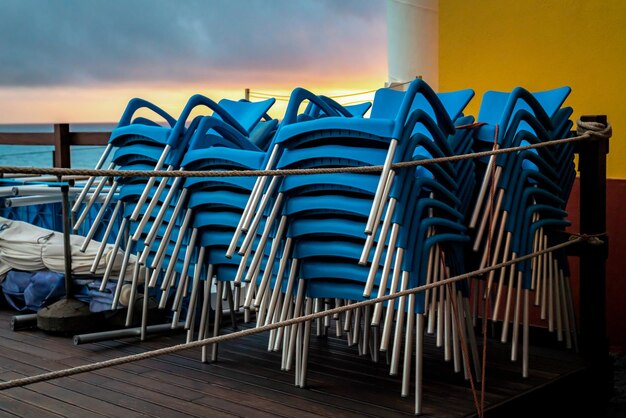 Chairs on table against sky during sunset