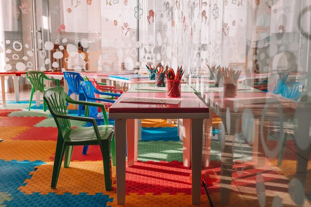 Chairs, table and toys. Interior of kindergarten