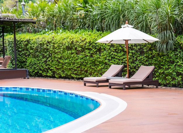 Photo chairs and umbrella in palm beach tropical holiday banner