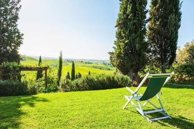 Chaise lounge on the green meadow. Tuscany, Italy