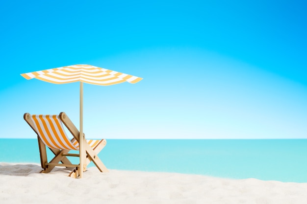 Chaise lounger under an umbrella on the sandy beach by the sea