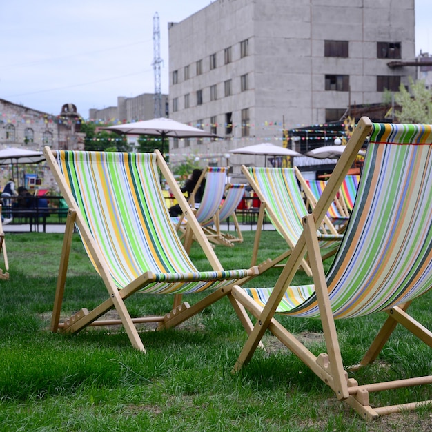 Chaise lounges on a lawn. 