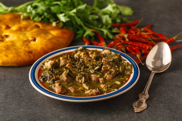 Photo chakapuli - georgian stew.made from lamb chops or veal, onions, tarragon leaves, cherry plums or tkemali