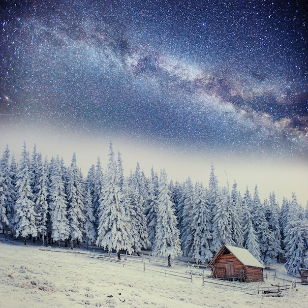 Chalets in the mountains at night under the stars