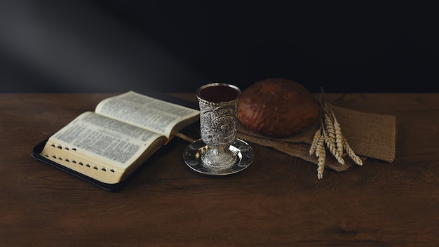 Chalice with wine and bread. Background with copy space. last supper