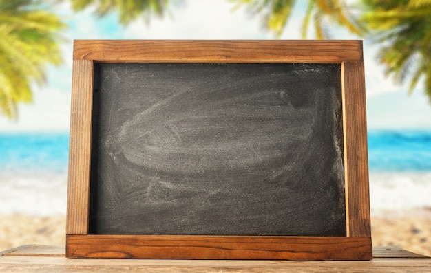 Chalk board on the background of the sea beach