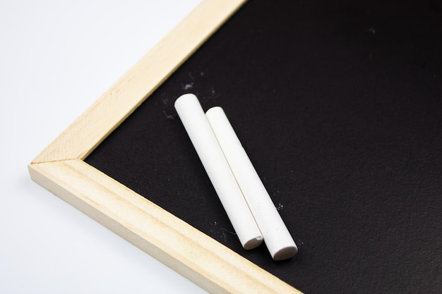 Chalk board and crayons on an isolated backgroundWooden board for drawing or writing with chalk