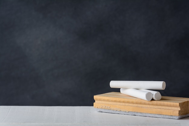 Chalk and eraser board on the white desk