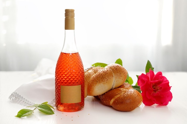 Challah bread covered with a special napkin shabbat wine on white background Traditional Jewish Shabbat ritual Shabbat Shalom