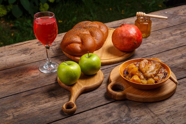 Challah pomegranate and honey on wooden boards for Rosh Hashanah