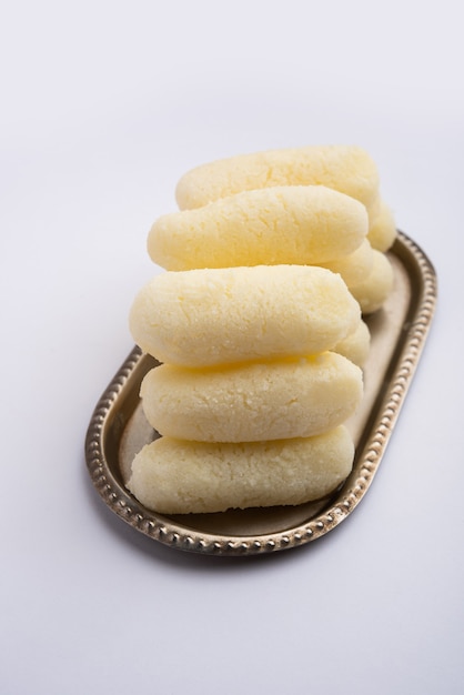 Cham cham is a Bengali sweet made by curdling milk and then shaping the coagulated solids to cylindrical shape pieces