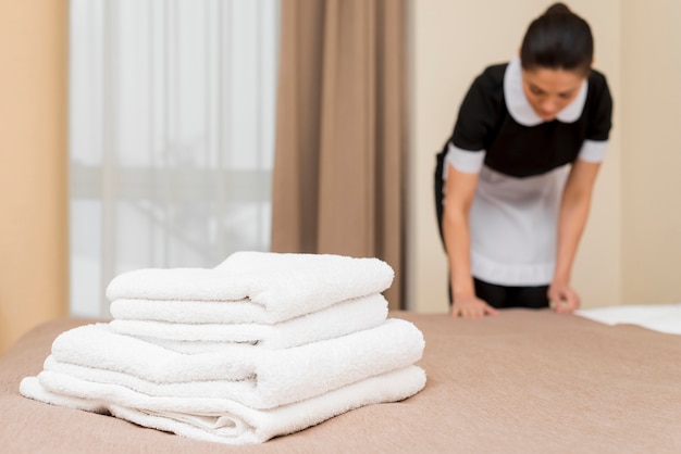 Chambermaid cleaning hotel room