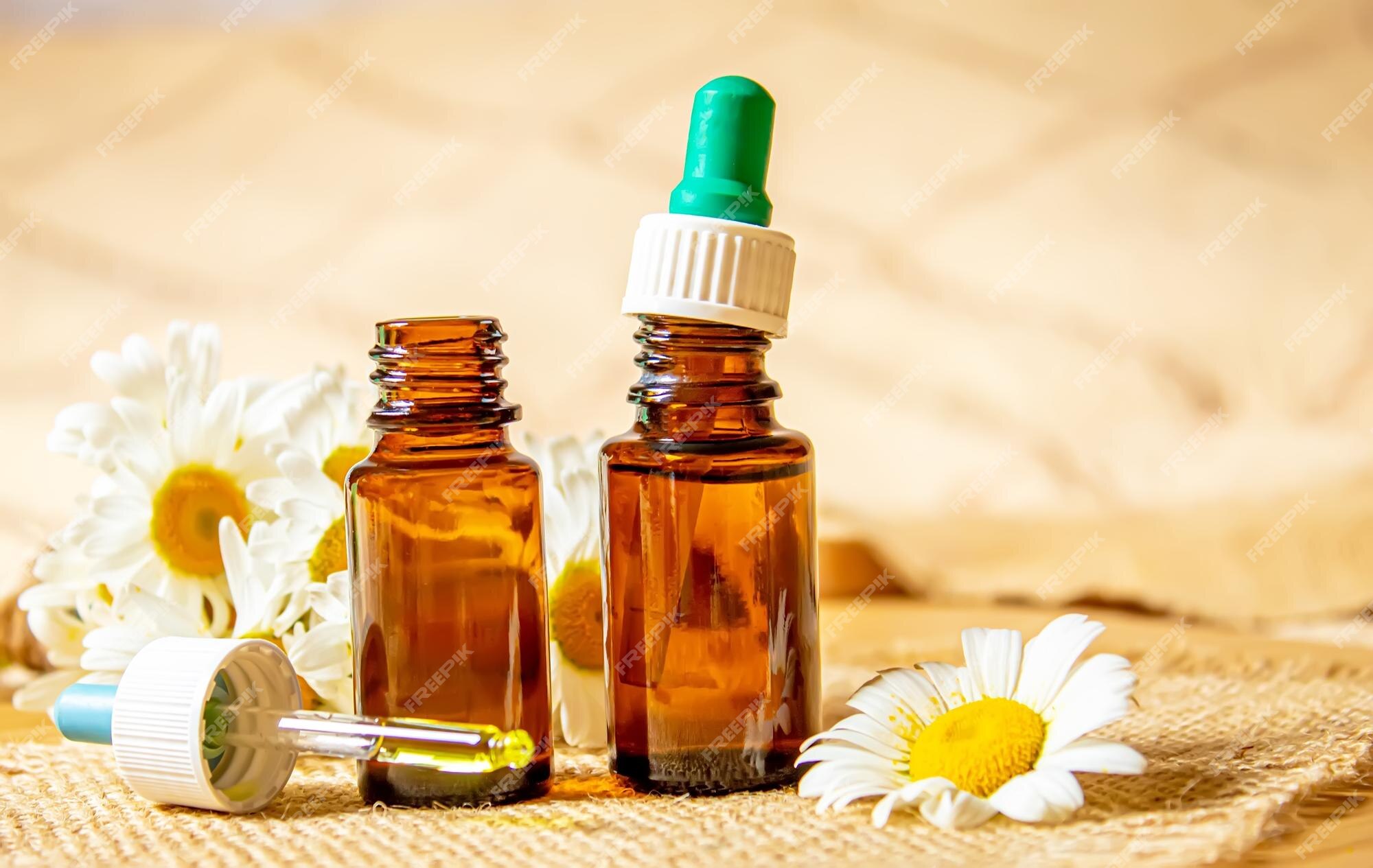 Premium Photo  Chamomile essential oil in a small bottle